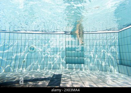 Pool view underwater swim person scene reflection floor tiles Stock Photo