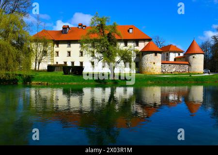 View of Otočec castle and a reflection of the castle in the water of Krka rive in Dolenjska, Slovenia Stock Photo