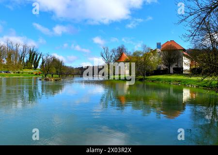 View of Krka river with a bridge across and Otočec castle in the shore in Dolenjska, Slovenia Stock Photo