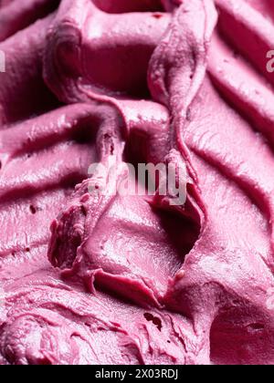 Frozen Pomegranate flavour gelato - full frame detail. Close up of a pink surface texture of Ice cream. Stock Photo