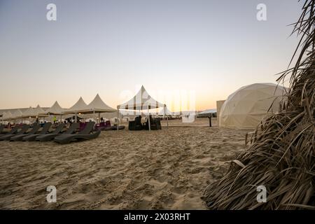 QIA desert camp at Inland Sea in Persian Gulf at sunset sky. Middle East, Arabian Peninsula. Inland sea is a major tourist destination for Qatar. Stock Photo