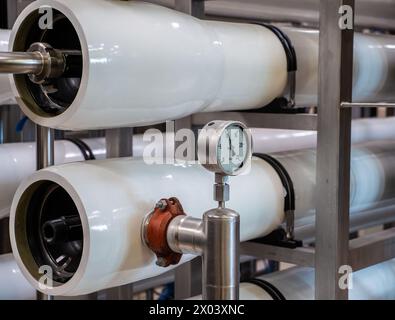 Pressure meter attached to filtration system in a water treatment facility. Stock Photo