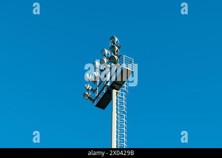 Lighting at the stadium. Spotlight against the blue sky. Light source. Stock Photo