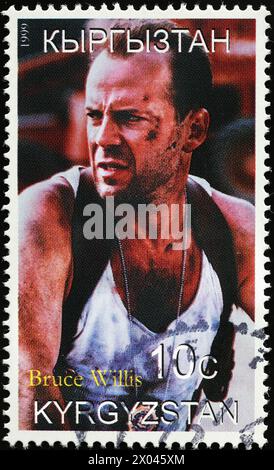 Bruce Willis in an action movie on postage stamp Stock Photo