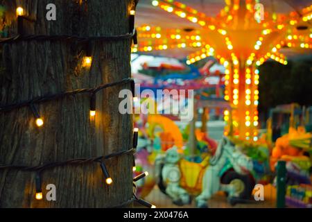 Multi-colored lights in an amusement park. Carousels. Recreation and entertainment. Stock Photo