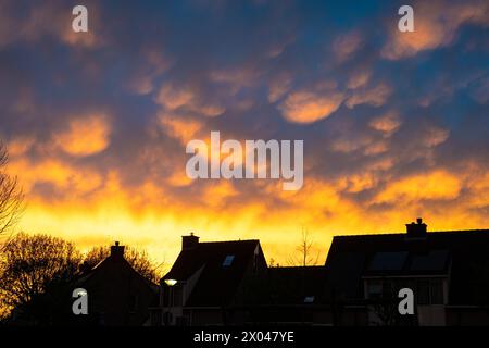 Colorful display of mammatus clouds at sunset after the passage of a thunderstorm Stock Photo