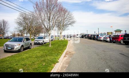 NORWALK, CT, USA - APRIL 8, 2024: Calf Pasture Beach in Norwalk with peoples watching American eclipse Stock Photo