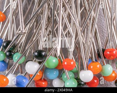 Background from sewing pins with multi-colored round heads Stock Photo
