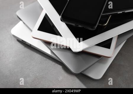 Many different modern gadgets on grey table, closeup Stock Photo