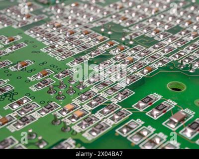 Green PCB with lots of resistors on it. Selective focus. Stock Photo