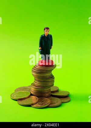 Executive standing firm on a group of disordered and unstable coins Stock Photo