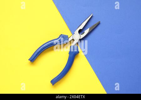 Needle nose pliers on color background, top view Stock Photo