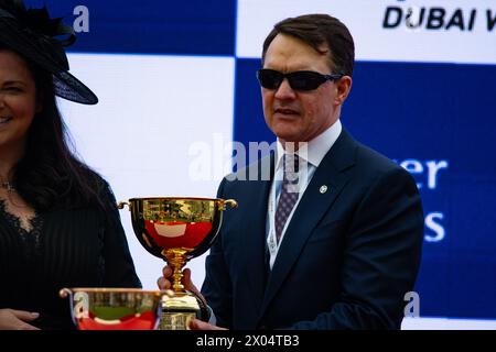 Dubai, United Arab Emirates. Saturday 30th March 2024. Trainer Aidan O'Brien collects his trophy after Tower Of London won the Group 2  Dubai Gold Cup Stock Photo