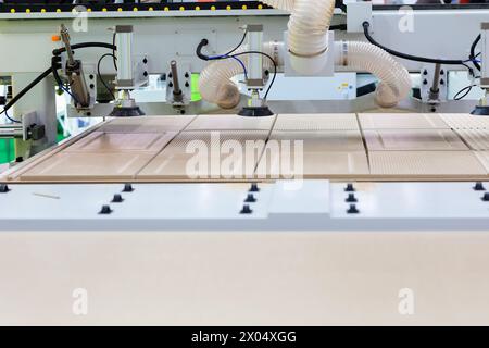 MDF furniture panels processing with woodworking CNC milling machine. Selective focus. Stock Photo