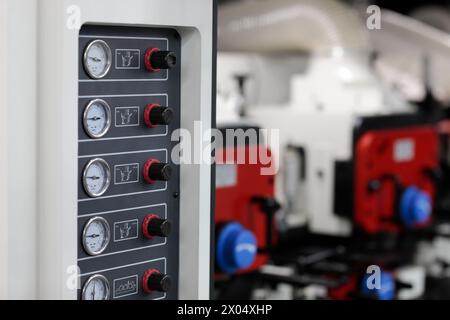 Pressure gauges and regulators on control panel of industrial machine. Selective focus. Stock Photo