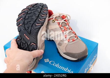 Sturdy brown hiking olumbia sneakers with laces in female hands buying new shoes Columbia Sportswear Company modern clothing footwear for outdoor Stock Photo Alamy