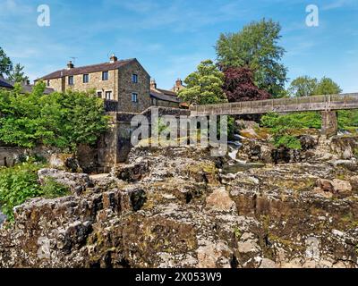 UK, North Yorkshire, Grassington, Tin Bridge over Linton Falls and River Wharfe. Stock Photo