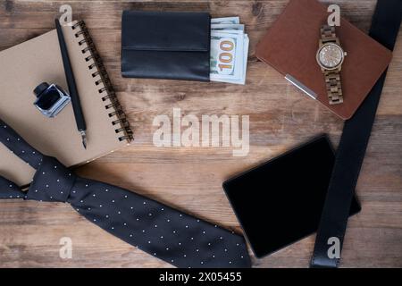 International Father's Day, empty blank for text, black tie, money American dollars in purse, wrist watch, e-book in leather case, top view on items, Stock Photo