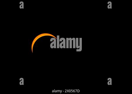 The solar eclipse before totality on April 8, 2024. Only a thin crescent of the sun is visible. Stock Photo