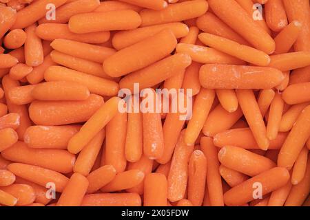 background composed of many orange baby cut carrots Stock Photo
