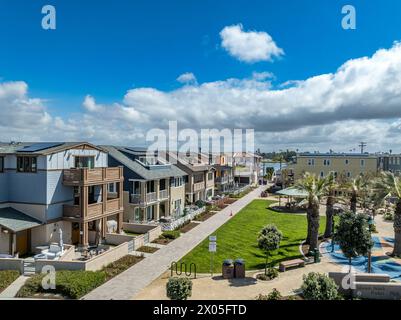 Aerial close up view of residential luxury single family beach houses on Mission Beach San Diego with covered porch, brown picket fence, patio furnitu Stock Photo