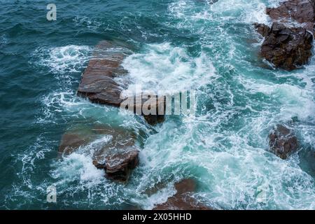 Waves swirling around rocks at Monument Cove, Acadia National Park, Mount Desert Island, Maine, USA. Stock Photo