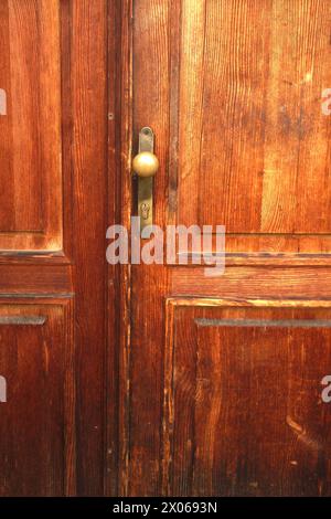 old wooden door and brass handle detail Stock Photo