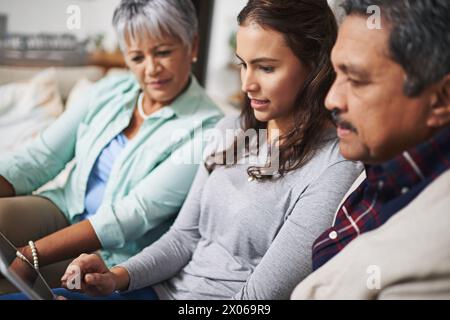 Relax, tablet and woman teaching parents networking on internet, mobile app or website on sofa. Talk, bonding and senior man and woman learning Stock Photo