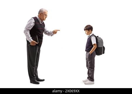 Full length profile shot of a strict male teacher reprimanding a schoolboy isolated on white background Stock Photo