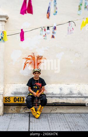 A Child In Costume Waits To Perform At The Salta Carnival, Salta Province, Argentina Stock Photo