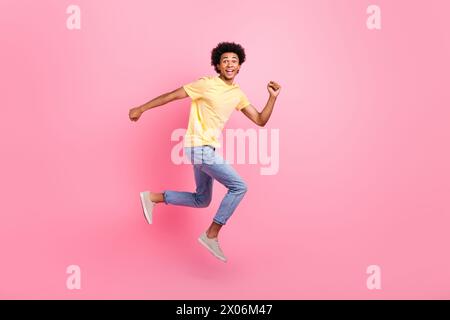 Full length portrait of overjoyed energetic person jumping rush isolated on pink color background Stock Photo