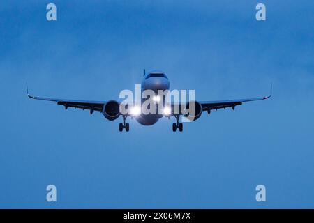 airplane approaching in the evening, Germany, Bavaria, Muenchen Stock Photo