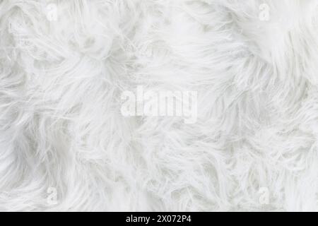 Full frame of soft fake white fur rug. Overhead top view plush pattern fabric. Stock Photo