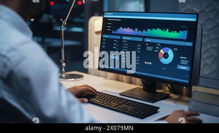 Close Up of a Businessman Working on Desktop Computer with Company's Growth, Statistics, Graphs and Pie Charts. Male Executive Director Managing Digital Projects, Typing Data, Using Keyboard and Mouse Stock Photo