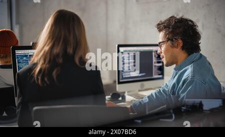 Smart Young Students Studying in University with Diverse Multiethnic Classmates. Scholars Collaborate in College Room on Computer Science Project, Writing Software Code in Successful Teamwork. Stock Photo