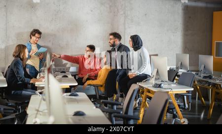 Diverse Multiethnic Group of Female and Male Students Sitting Together in Infographics Room, Collaborating on a School Project. Young Scholars Talking, Study Software Development or Computer Science. Stock Photo