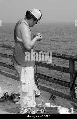 Man baits hook at Chesapeake Bay USA Stock Photo