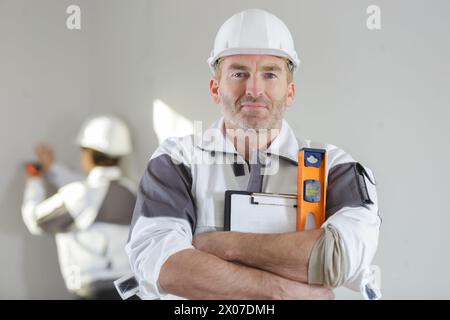 construction worker holding spirit level Stock Photo