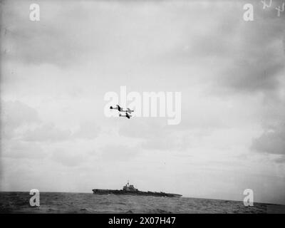 PREPARATIONS FOR NORWEGIAN OPERATIONS. OCTOBER 1941, ON BOARD THE DESTROYER HMS BEDOUIN. HMS VICTORIOUS AND HMS KING GEORGE V ALONG WITH ESCORTING DESTROYERS DURING SEVERAL DAYS OF PREPARATION FOR NORWEGIAN OPERATIONS. - Three Fairey Fulmars flying over HMS VICTORIOUS Stock Photo