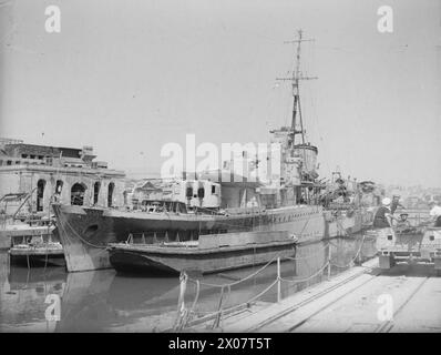 BOMB DAMAGE IN MALTA AFTER BIGGEST RAID YET. 7 APRIL 1942. BOMB DAMAGE TO THE DOCKYARDS. - HMS KINGSTON in No 4 Dock where she suffered severe damage Stock Photo