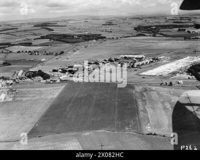 ROYAL AIR FORCE FLYING TRAINING COMMAND, 1940-1945. - Oblique aerial view of Prestwick airfield from the west, showing the northern section of the airfield, including the Scottish Aviation Ltd complex, and the threshhold of the 6,600 ft x 300 ft concrete main runway (14/32) under construction (extreme right). Immediately to the left of the runway can be seen the remains of the Scottish Flying Training School buildings, the central portion of which, consisting of the administration offices and Watch Office, was burned down on 3 February 1941. At the left of the complex is the Palace of Engineer Stock Photo