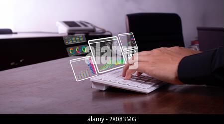 close-up of man's hands typing and reviewing business data, positive graphs Stock Photo