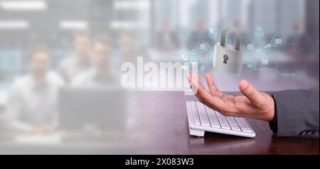cybersecurity concept: businessman at his desk holds hologram of padlock with security icons. blurred background Stock Photo