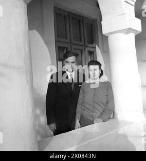 Socialist Republic of Romania, approx. 1975. Married couple posing on the front porch of their house. Stock Photo