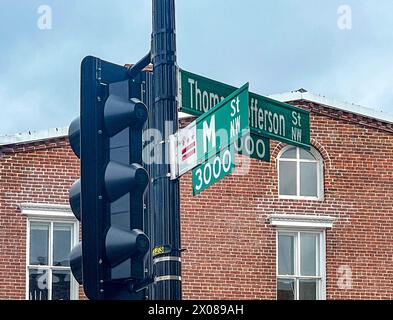 Washington DC - US - Mar 23, 2024 Horizontal view of a signpost at the corner of M Street NW and Thomas Jefferson Street NW in the heart of historic G Stock Photo