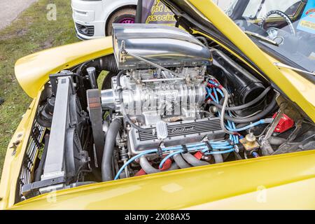 A supercharged V8 engine in a hot rod car. Stock Photo