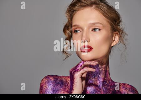 A young woman exudes classic beauty in a studio setting, confidently posing in a striking purple bodysuit. Stock Photo