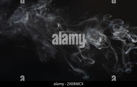 Gas white smoke swirls isolated on black studio background Stock Photo