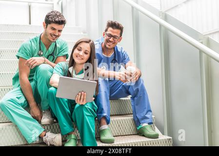Medics having coffee and watching tablet Stock Photo
