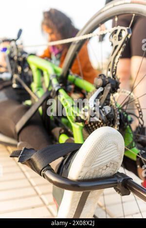 Focus on an unrecognizable handbike as a determined female athlete gets ready for racing. Stock Photo